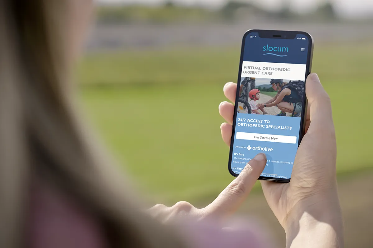 Woman accessing Slocum's virtual orthopedic platform on her phone