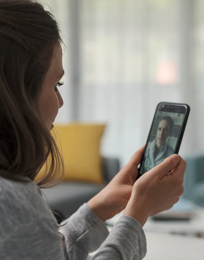 woman using slocum virtual urgent care on her phone